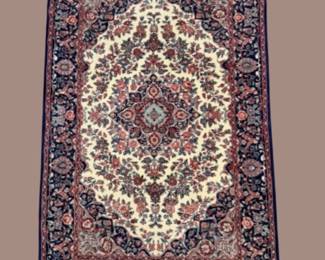 Dark burgundy and ivory traditional rug with ornate central medallion