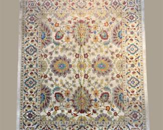 Ivory floral rug with soft blue, gold, and pastel botanical details