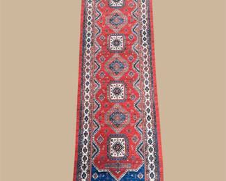 Narrow red runner with repeating blue and ivory diamond motifs