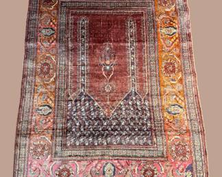 Rust and burgundy traditional rug with detailed central design