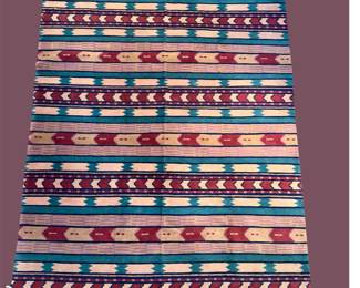 Colorful striped rug with red, blue, cream, and geometric accents