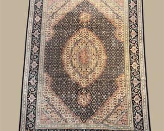 Dark traditional rug with large central medallion and intricate border