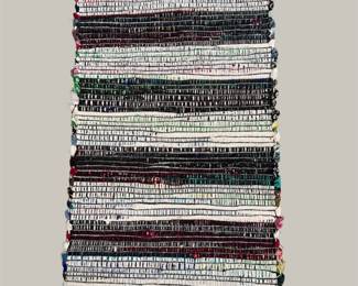 Handwoven striped rug with alternating neutral and dark bands