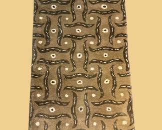 Olive green geometric rug with repeating abstract motif