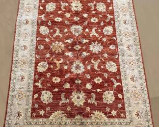 Deep red floral rug with ivory botanical motifs