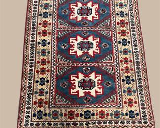 Dark traditional rug with three bold geometric medallions