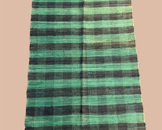 Green and black checkered rug with bold contemporary design