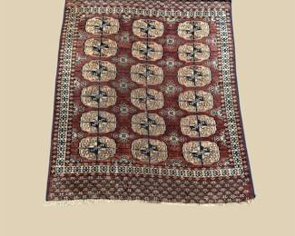 Burgundy and ivory rug with repeating oval motifs