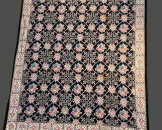 Black and ivory floral rug with dense repeating pattern
