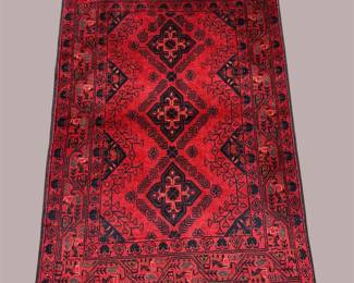 Bold red and black geometric rug with repeating diamond pattern