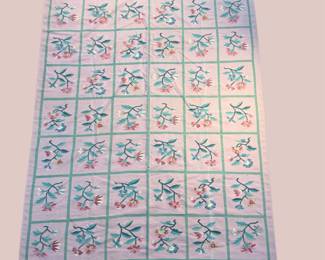 Light blue and ivory geometric rug with repeating floral tile pattern