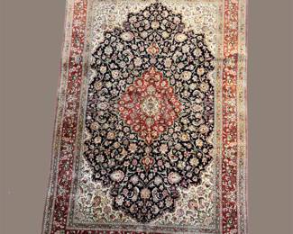 Dark green and ivory traditional rug with rust central medallion