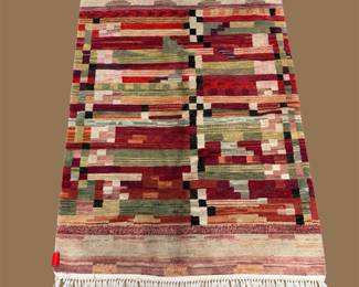 Multicolor geometric rug with bold abstract blocks and stripes