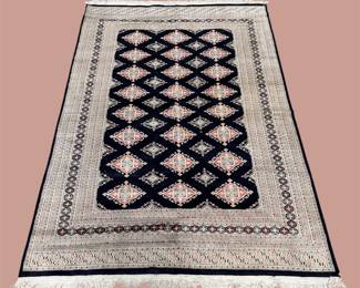 Black and ivory geometric rug with repeating diamond design