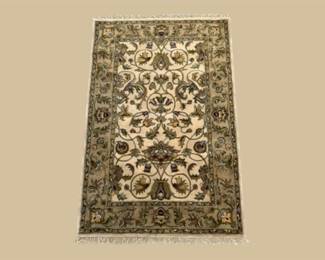 Black and ivory floral rug with ornate scrolling botanical pattern