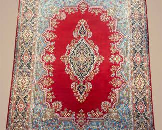 Vibrant red traditional rug with ornate ivory and blue central medallion