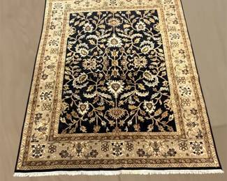 Black and ivory floral rug with ornate traditional pattern