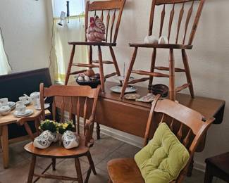 slender diningroom table with four chairs, folds out 