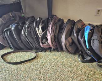 one row of back packs and travel bags, more to come