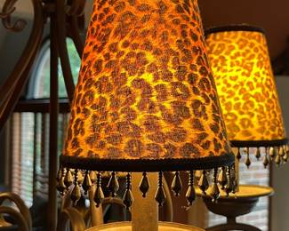 Wrought-iron scroll chandelier with leopard-print lamp shades $120