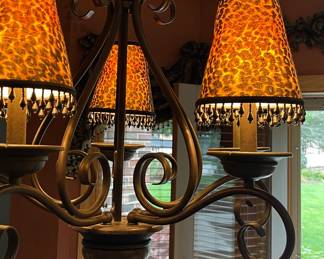 Wrought-iron scroll chandelier with leopard-print lamp shades $120