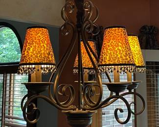 Wrought-iron scroll chandelier with leopard-print lamp shades $120