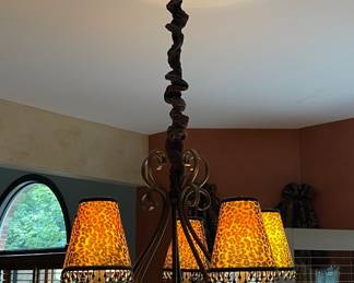 Wrought-iron scroll chandelier with leopard-print lamp shades $120
