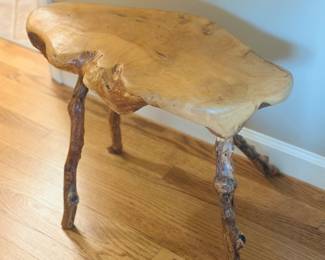 rustic live-edge slab stool or plant stand, made from a natural wood slab