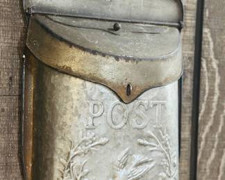 vintage galvanized tin wall-mounted mailbox with an embossed bird and floral wreath design