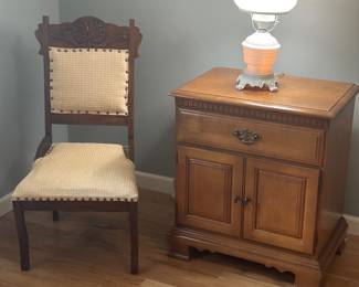vintage maple nightstand, an Eastlake-style cane-back side chair, and a vintage hurricane table lamp.