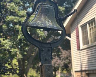cast iron farm or school bell mounted on a yoke