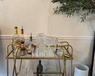 Modern Gold & Glass Bar Cart Elegant gold metal bar cart with two glass shelves. Great for entertaining, a coffee station, or home décor. In good condition.