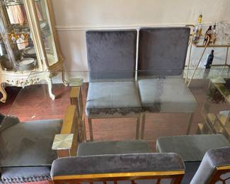Modern Glass Dining Table with 6 Chairs – Gold Base Beautiful contemporary dining set featuring a thick tempered glass tabletop with a gold geometric metal base and six upholstered gray dining chairs. Great condition and perfect for a modern dining room. * Seats 6 comfortably * Glass top * Gold metal base * Six upholstered chairs included