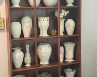 Collection of elegant Lennox and decorative porcelain vases displayed in a beautiful cabinet. Quality home décor, collectible ceramics, and fine decorative accents available at this Tavares, FL estate sale by Kinfolk Estate Sales.