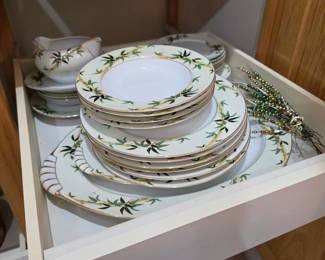 Elegant fine china dinnerware set featuring a timeless floral pattern with gold trim, including dinner plates, bowls, serving pieces, and matching tableware. Quality dining essentials available at this Tavares, Florida estate sale hosted by Kinfolk Estate Sales.