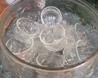 Vintage clear pressed glass punch bowl with matching punch cups featuring an embossed grape motif. Perfect for entertaining, weddings, holidays, vintage décor, and collectible glassware enthusiasts. Available at the Tavares, FL estate sale hosted by Kinfolk Estate Sales.