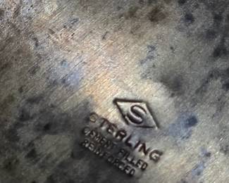 Close-up of the hallmark on the vintage sterling weighted silver bud vase. Marked "STERLING REINHOLD EMBOSSED," confirming authentic sterling silver craftsmanship. A beautiful collectible for sterling silver enthusiasts and antique collectors.