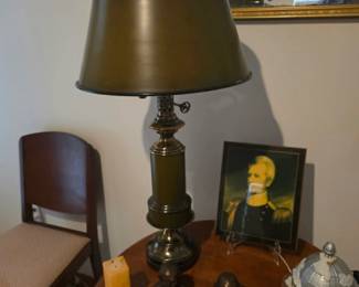 Elegant vintage table lamp with a classic metal base displayed alongside decorative artwork, accent furnishings, and collectible home décor. Discover timeless decorating pieces at this Tavares, Florida estate sale hosted by Kinfolk Estate Sales.