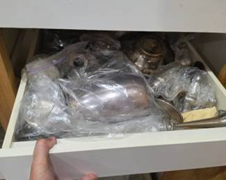 Drawer filled with sterling silver serving pieces, hollowware, and decorative items. This estate features an outstanding collection of authentic sterling silver, including tea service pieces, serving accessories, bud vases, and collectible silverware. A must-see for sterling silver collectors, antique enthusiasts, and precious metal buyers at the Kinfolk Estate Sale in Tavares, Florida.