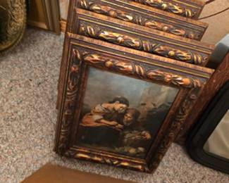 Collection of framed artwork featuring ornate carved wood-look frames and classic decorative prints. Beautiful wall décor, framed art, and home accents available at this Tavares, Florida estate sale hosted by Kinfolk Estate Sales.
