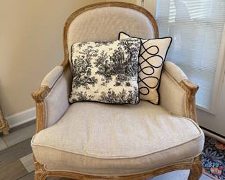Elegant upholstered accent chair with carved wood frame