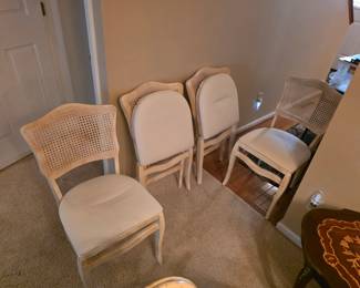 Vintage folding chairs with caned backs.