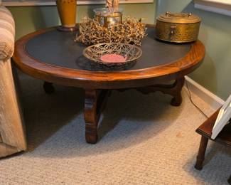 Round coffee table with heavy slate top.