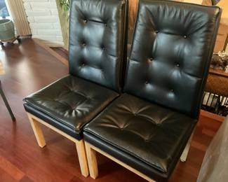 Two of the 6 leather dining chairs