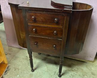 Martha Washington sewing cabinet with two flip top compartments and three front drawers.