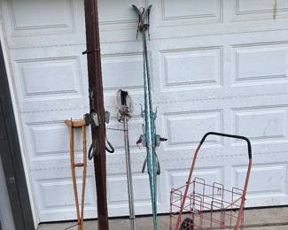 A pair of ski jump skies and a collapsable shopping cart... a pr of crutches!