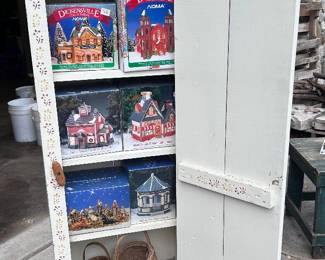 inside the 6 shelf hand painted wood cabinet featuring an assortment of DickensVille lighted buildings.