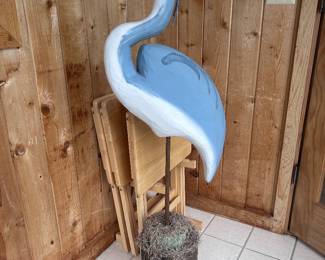 A hand carved wooden blue heron mounted on the wood base with Spanish moss accent.