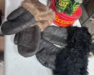 Six pack of 4077th Mash beer, (five are full and one is empty and a little beat up), stopenbach meat tin, two pair a very warm mittens. The pear on the right could be bear fur.