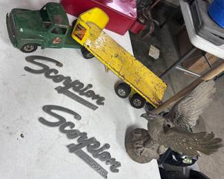 A Buddy L farm machinery Hauler, two 1960s Scorpion ‘Trail-a-sled snowmobile emblems from Crosby MN. A cast metal American eagle w/ mounting bracket for the wall.
